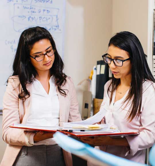 Admissions counselor at Loyola Law University helping student with her online law courses